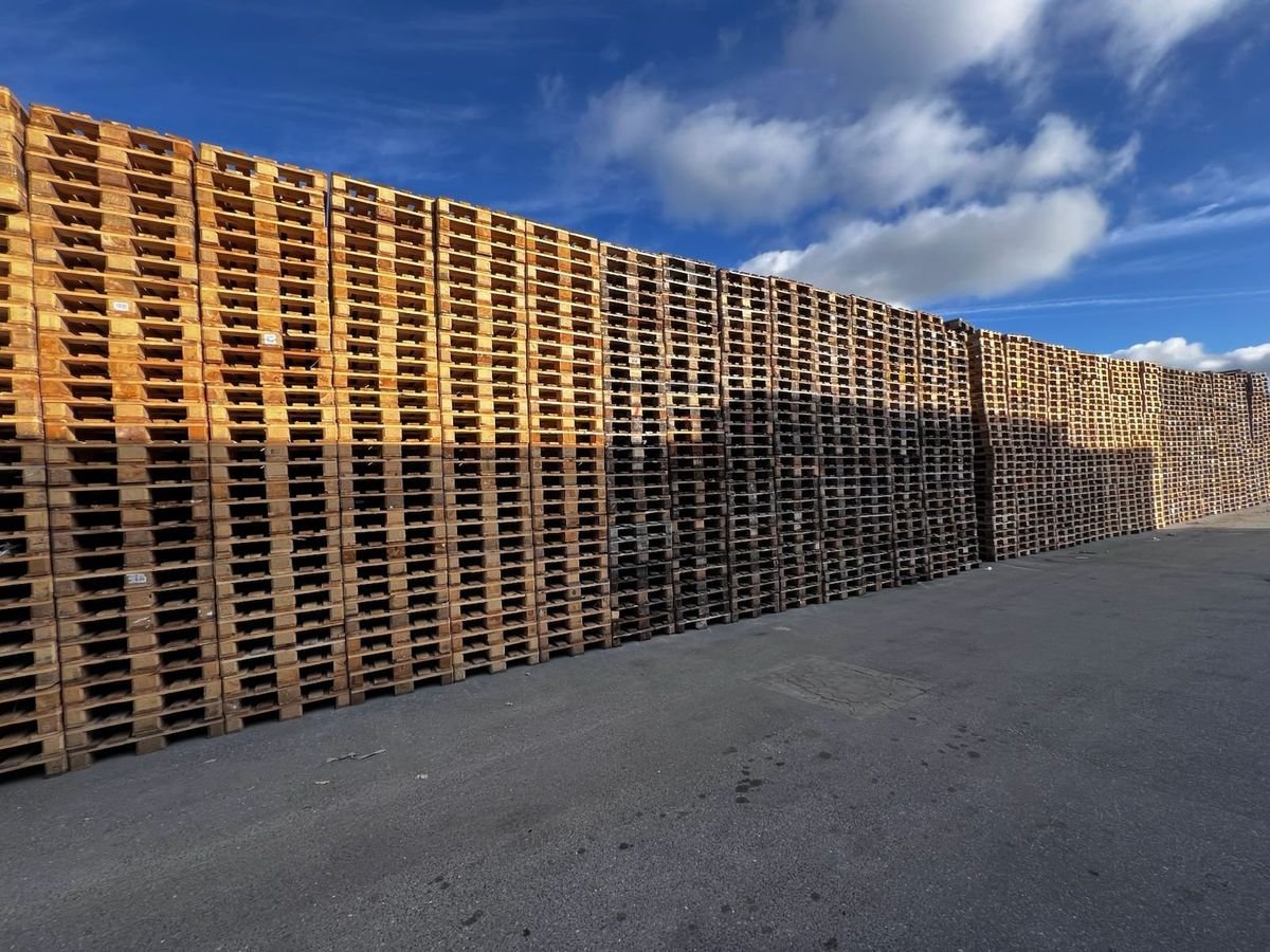 Stacked wooden pallets in stock at the DirectPAL depot near Paris